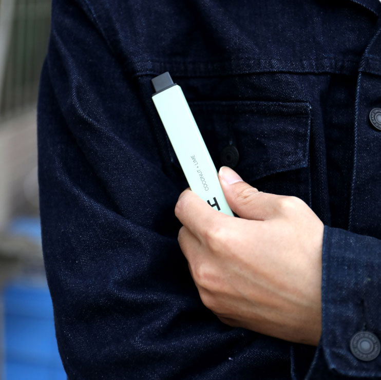 Man wearing Denim Jacket Holding a Vape